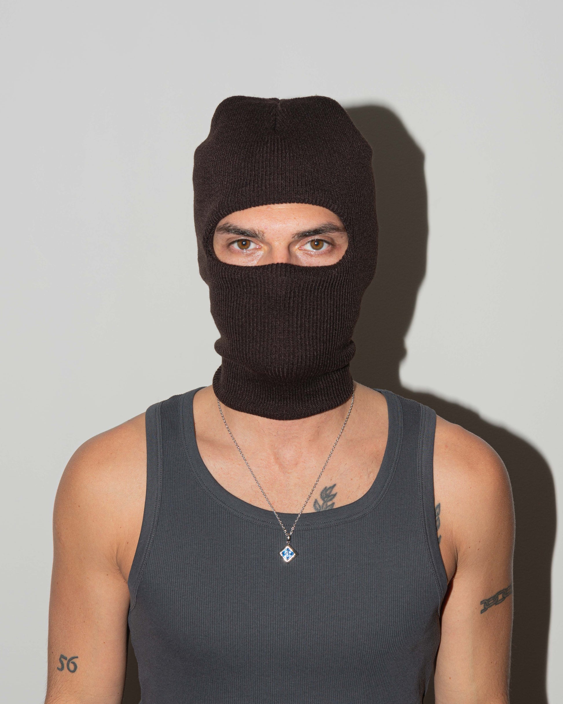 man wearing Via Savona pendant necklace with 18kt white gold coating rhombus shaped princess-cut stone in sapphire blue