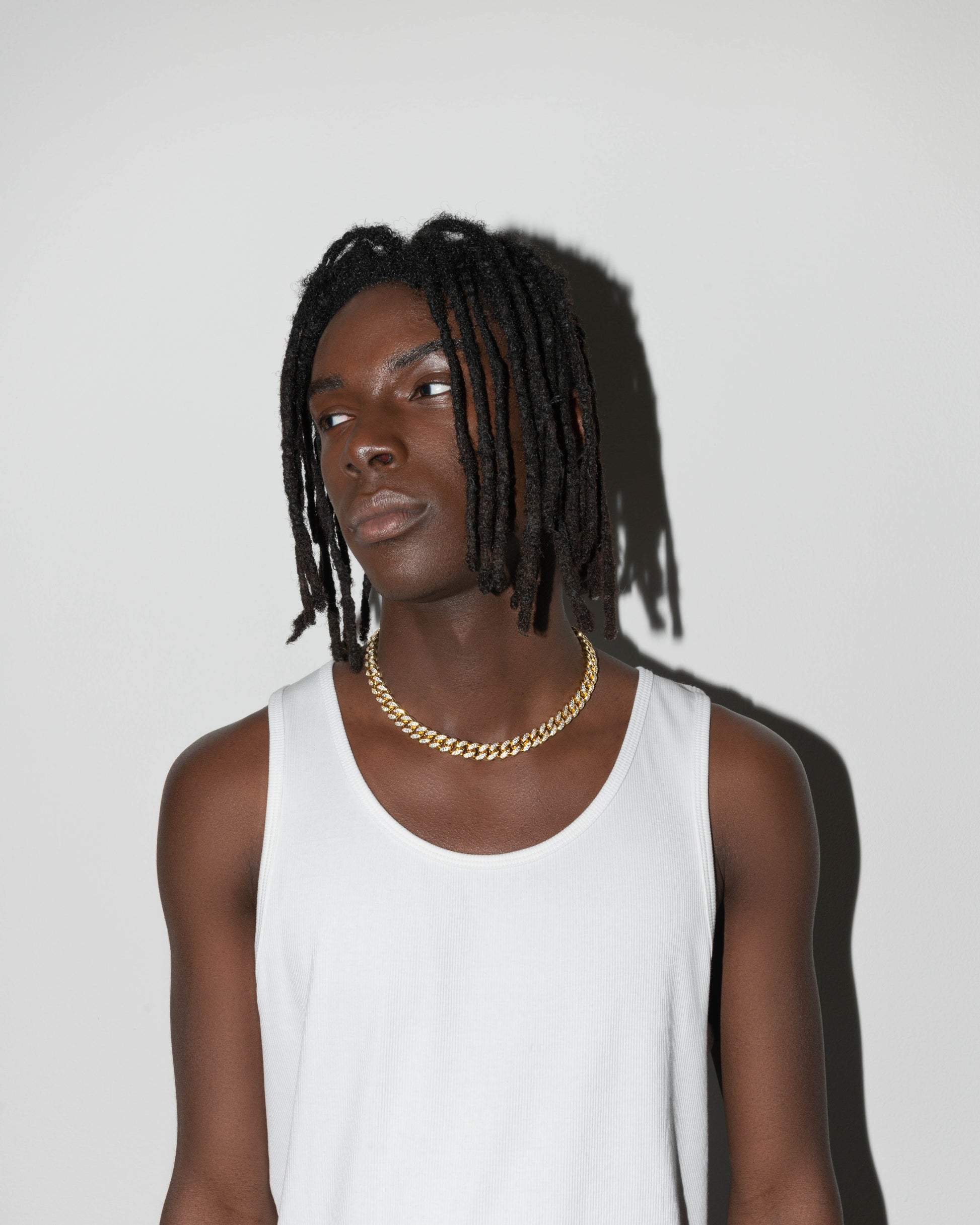 street style man wearing 18k yellow gold coated cuban chain necklace with hand-set micropavé stones in white