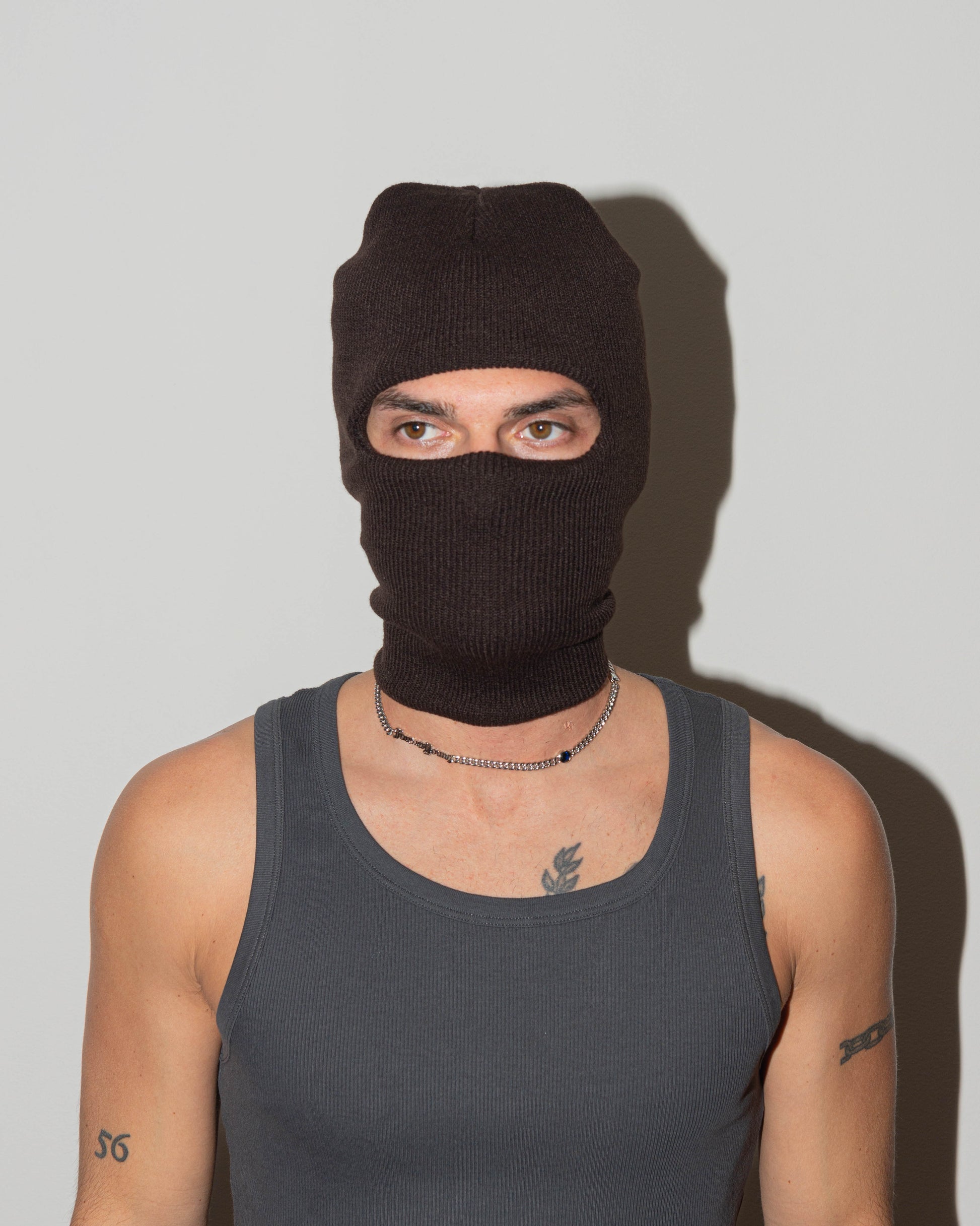 man wearing forever Young cuban chain necklace with 18kt white gold coating, mixed shape bezel stones in diamond white, burna blue, green, chocolate and "Forever Young" central metal tag