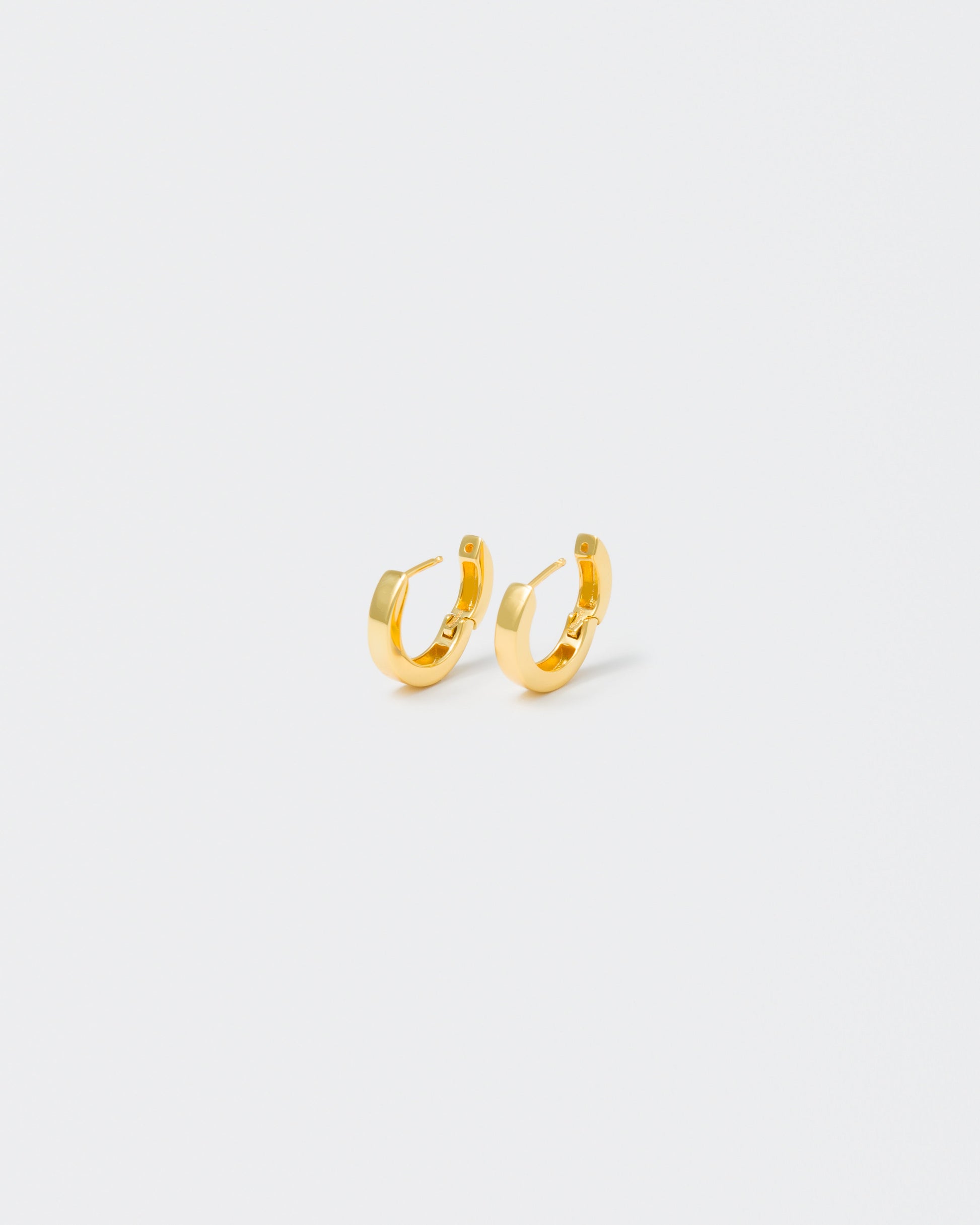 18k yellow gold coated hoop earrings with lasered logo and details on the inside