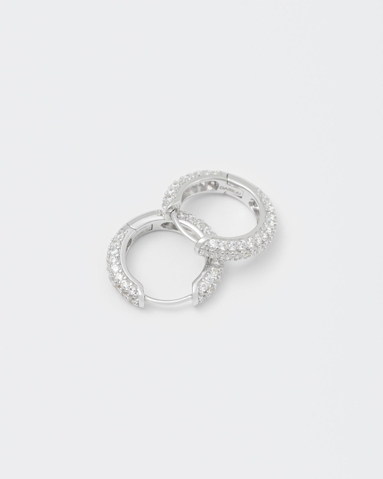 18k white gold coated hoop earrings with all around hand-set micropavé stones in white and lasered logo on the inside