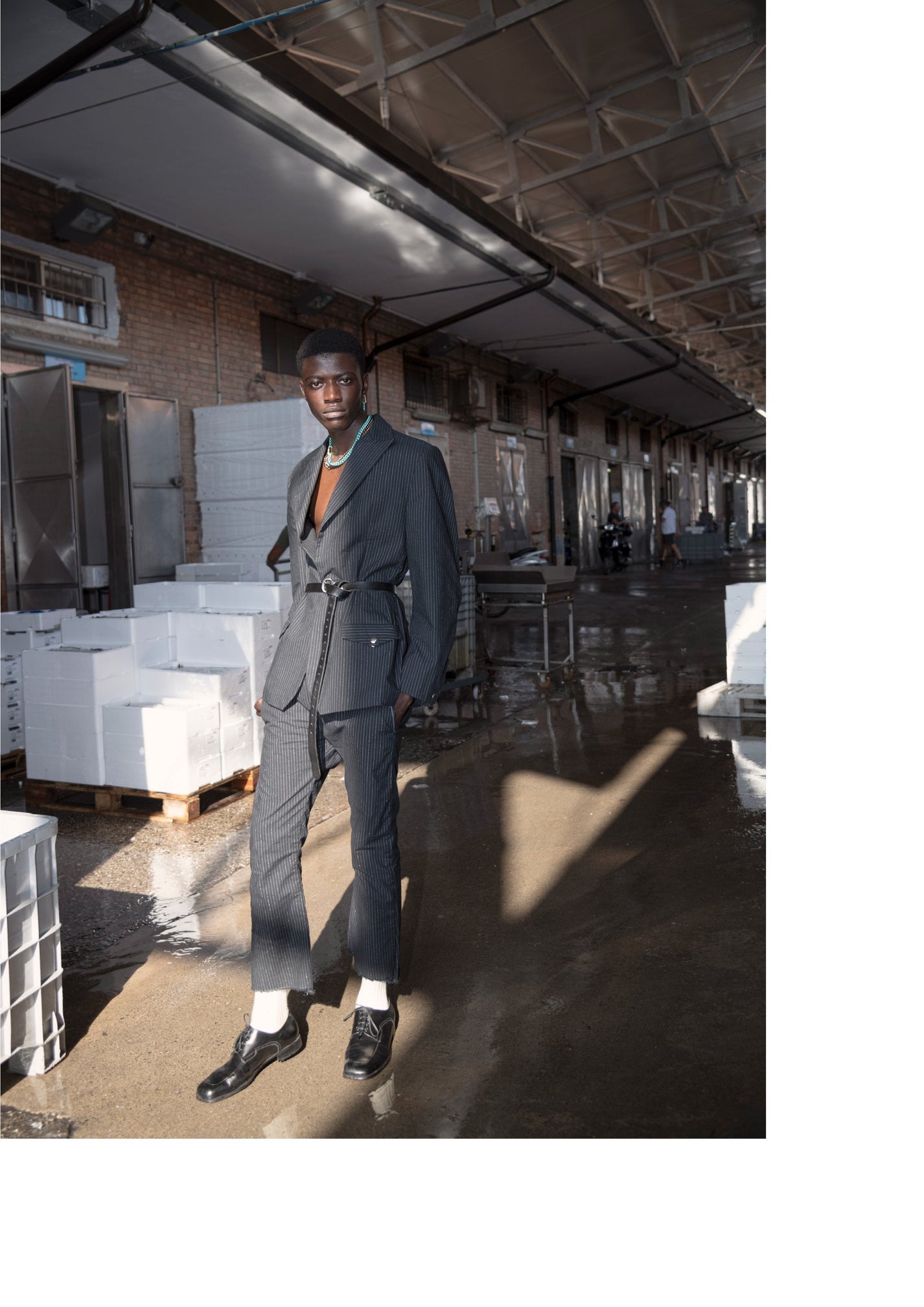 DARKAI Raw Energy Lookbook SS22 Man in urban landscape with gold necklaces