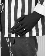 man with black suit wearing stainless steel white ring with stores