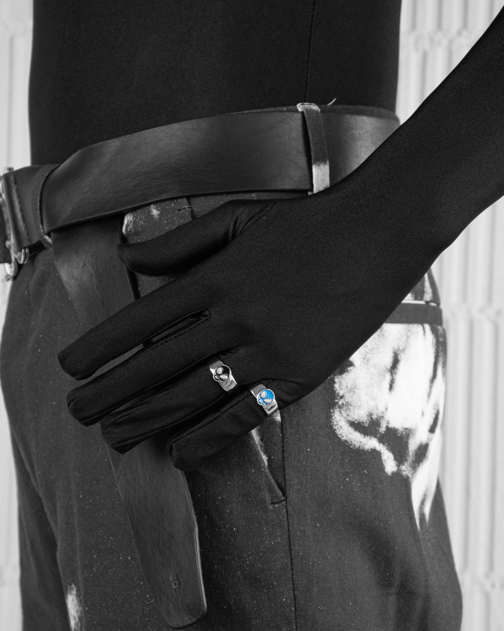 man with black suit wearing stainless steel white ring with blue and black alien face