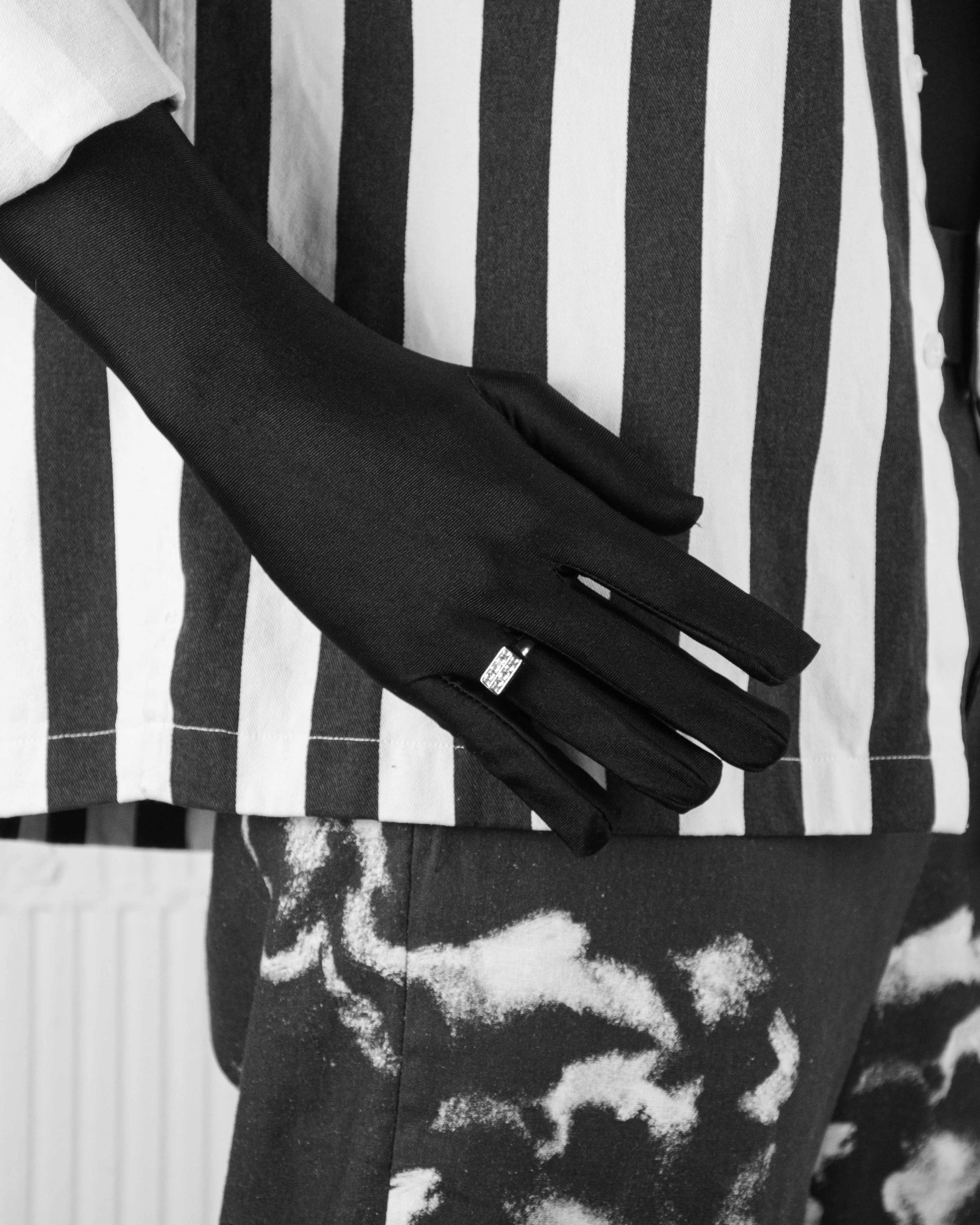 man with black suit wearing stainless steel white ring with stores