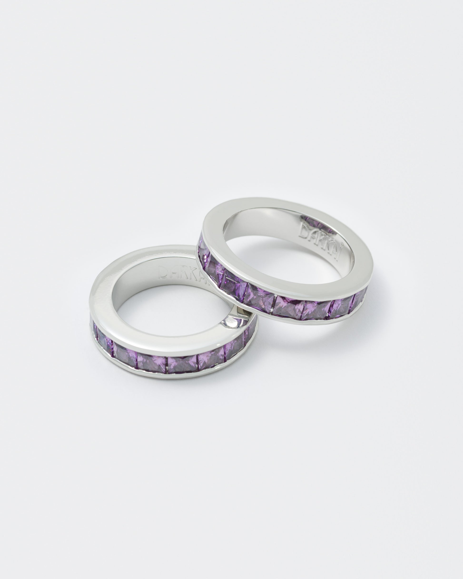 detail of white ring with purple stones 