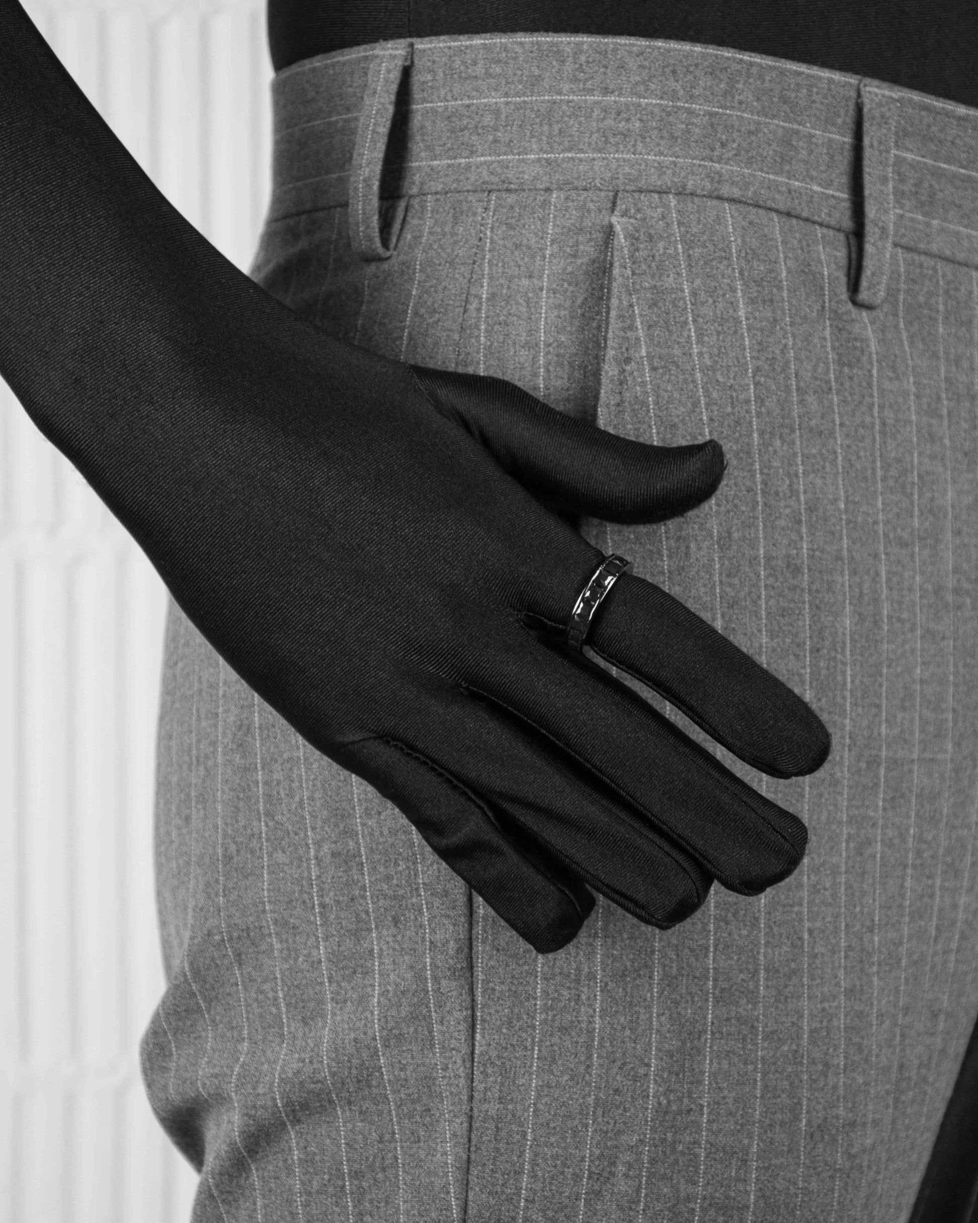 man with black suit wearing black ring with black stones