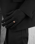 man with black suit wearing white ring with heart