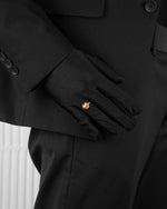 man with black suit wearing yellow ring with heart