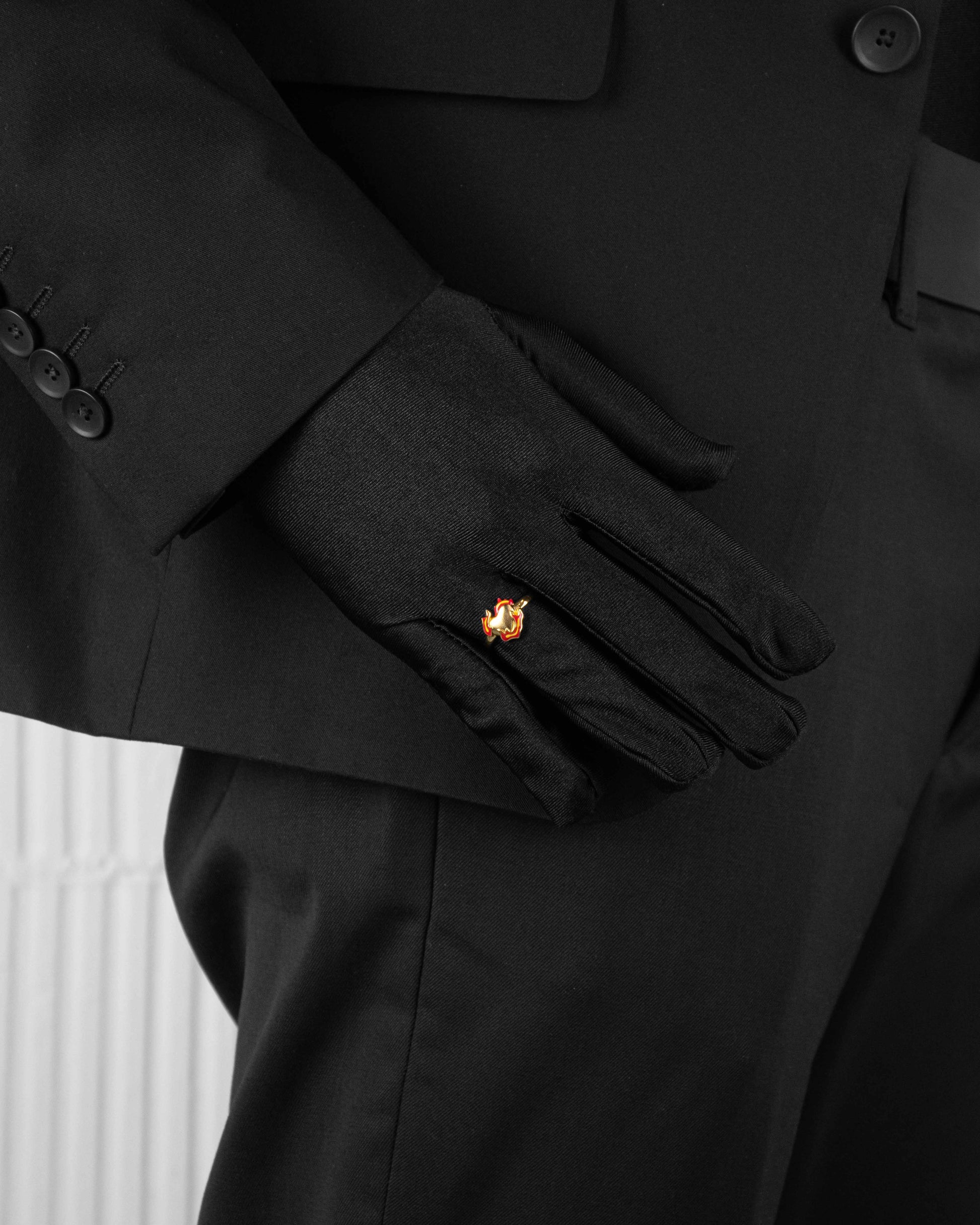 man with black suit wearing yellow ring with heart