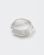 detail of octagonal stainless steel white ring with stores fon man end woman