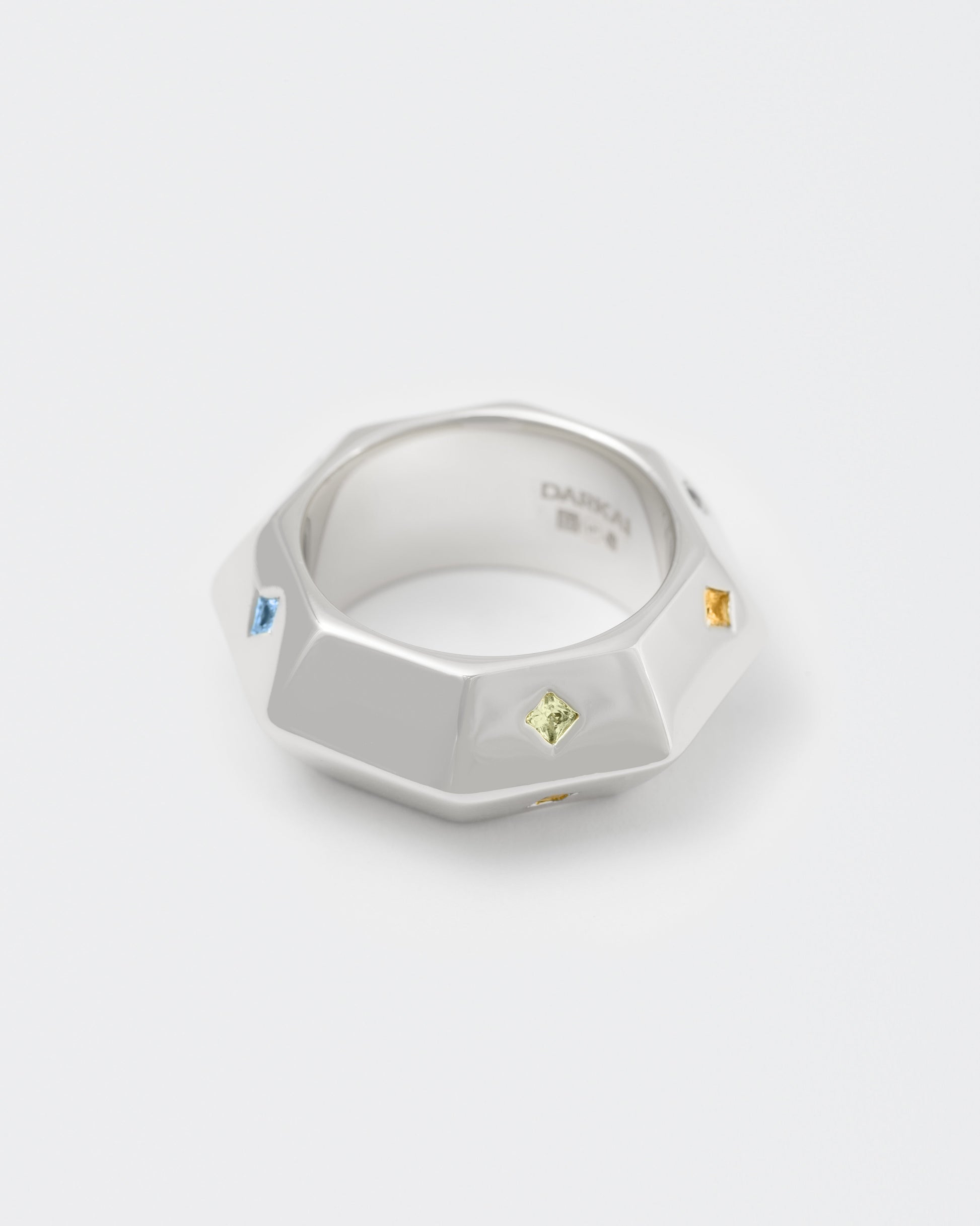 detail of octagonal stainless steel white ring with stores fon man end woman