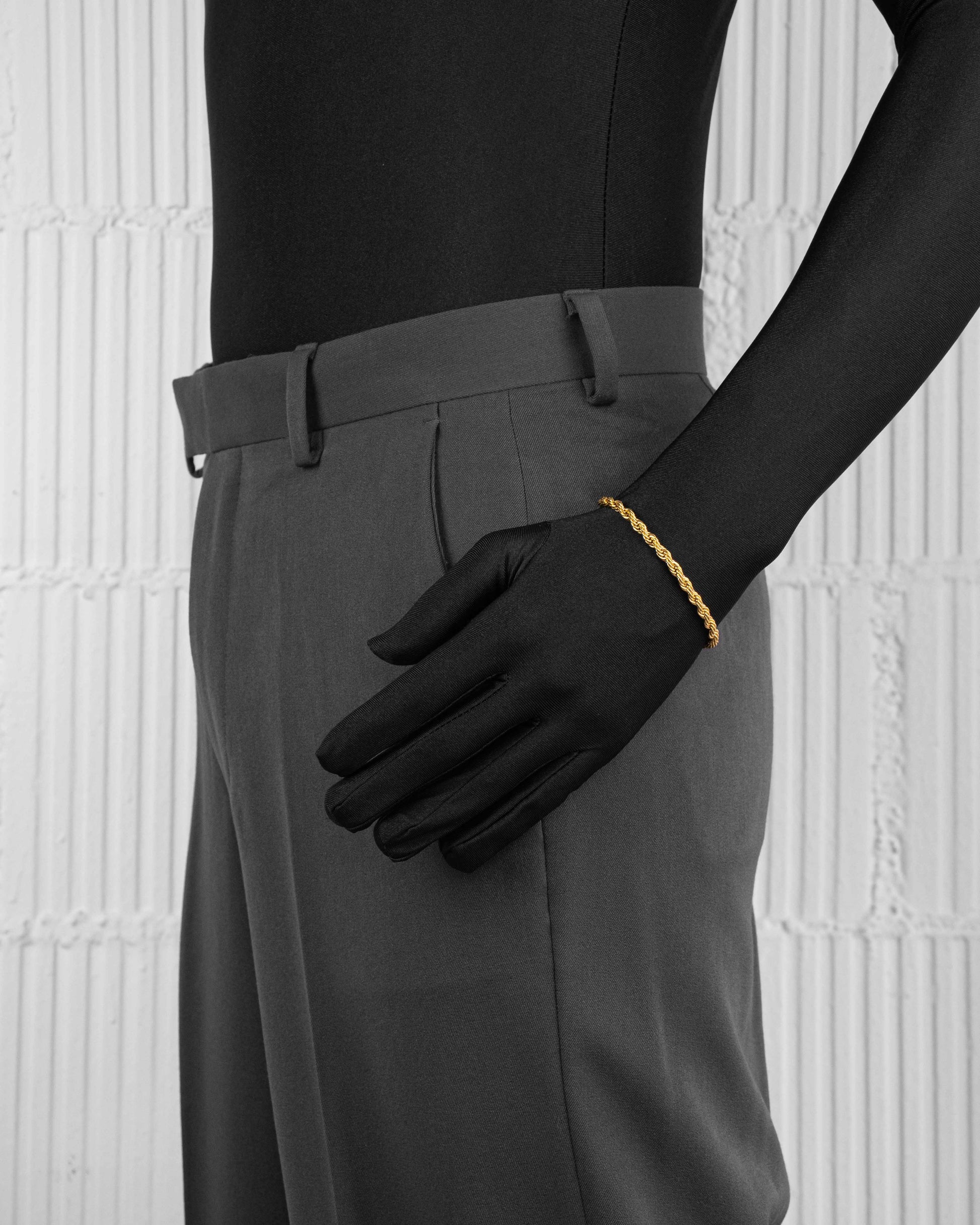 man with black suit wearing steel gold rope bracelet