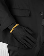 man with black suit wearing cold cuban pavé bracelet