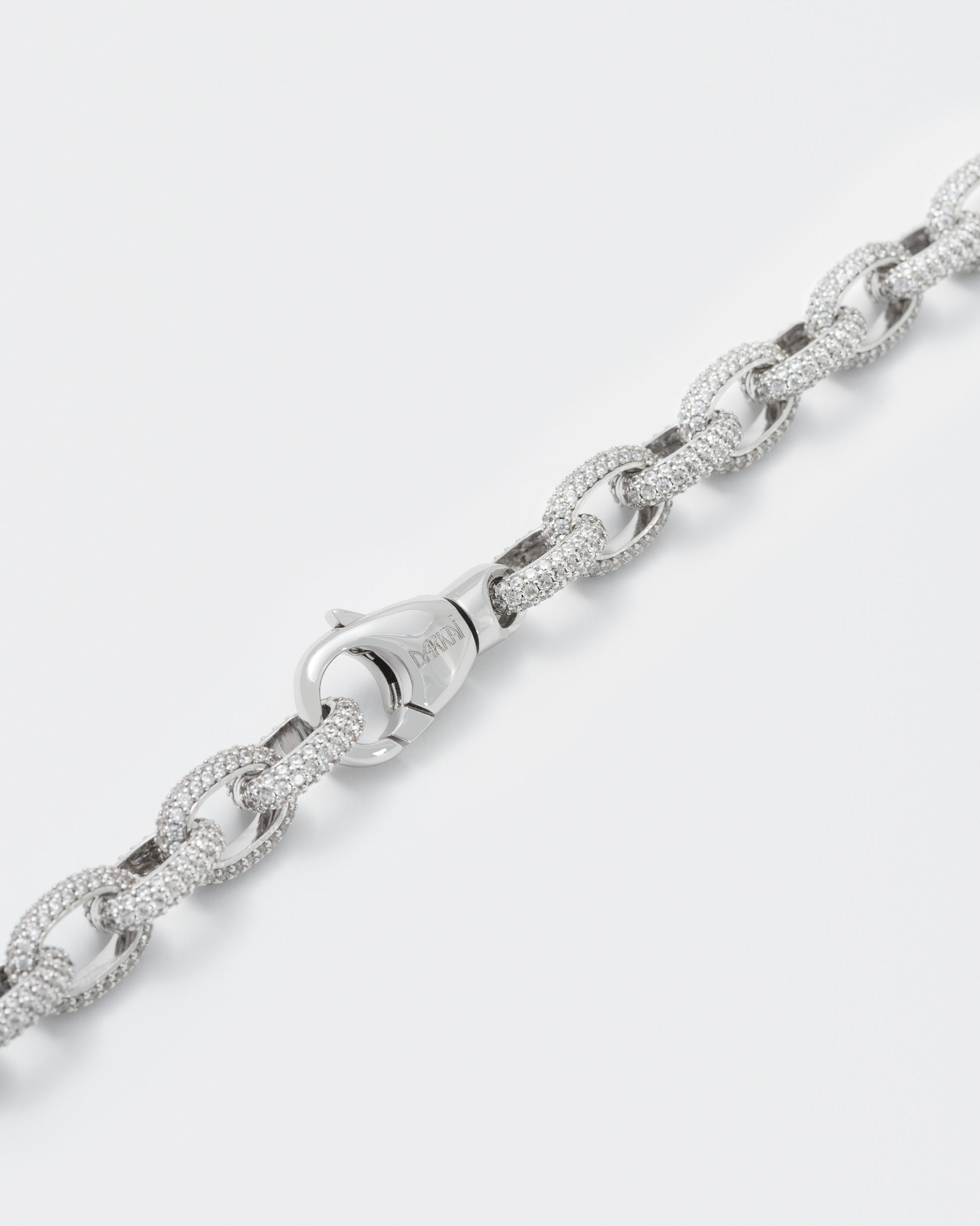 detail of 18k white gold coated rolo chain bracelet with all-around hand-set micropavé stones