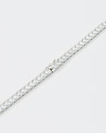 detail of 18k white gold coated tennis chain bracelet with white hand-set princess-cut stones