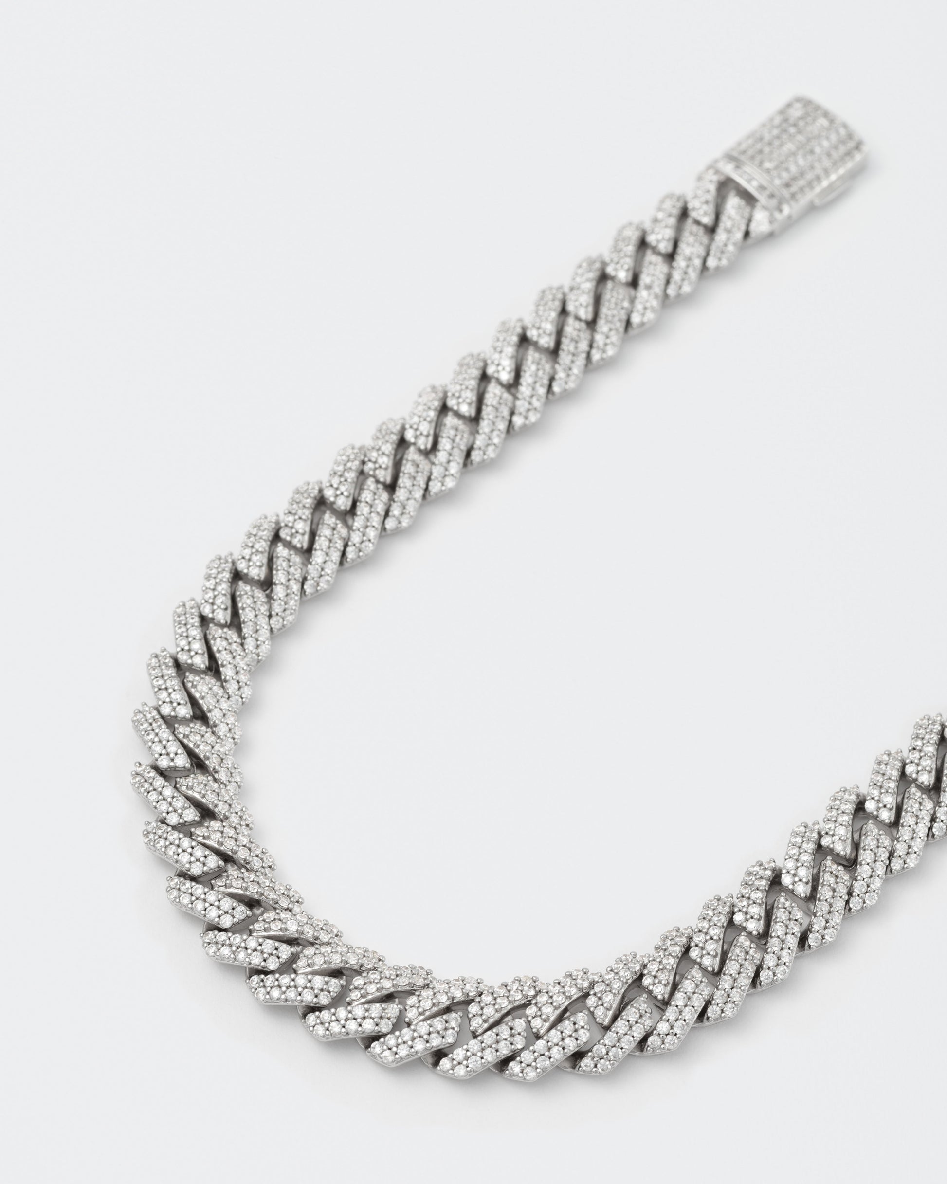 detail of 8k white gold coated mini prong chain bracelet with hand-set micropavé stones in white