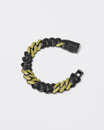 Prong chain bracelet with deep black PVD coating and hand-set micropavé stones in black and golden yellow. Fine jewelry grade drawer closure with logo