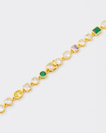 detail of clasp bracelet with hand-set stones in different shapes and colors. Mix of rectangular, square, round and heart-shaped stones in white, amethyst, emerald green and golden yellow