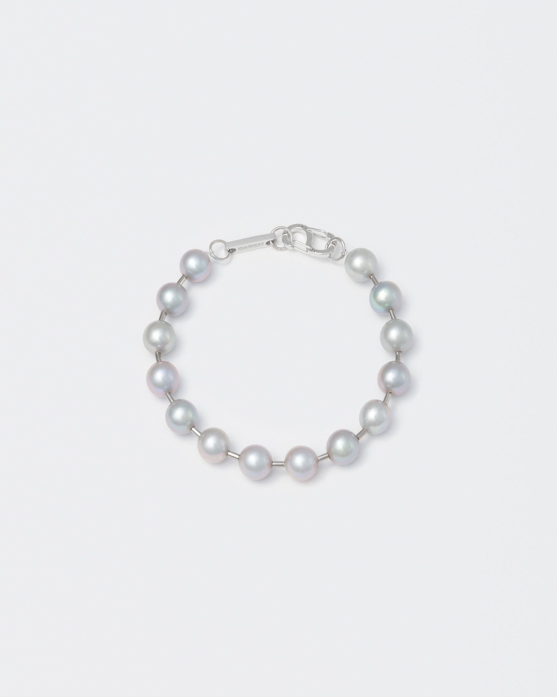 Natural Indonesian freshwater pearls bracelet with ematite spacers and 18k white gold coated carabiner clasp with logo. 9mm natural freshwater pearls in silver grey.