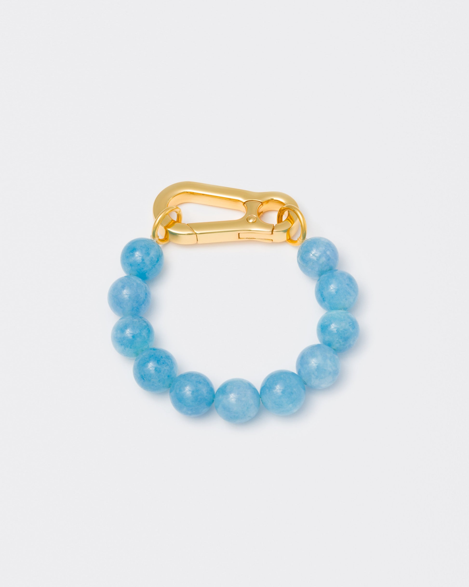 Aquamarine stones bracelet with 18k yellow gold coated lasered logo oversize carabiner clasp.