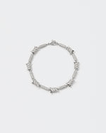 Barbed Wire bracelet with 18kt white gold coating and hand-set micropavé stones in diamond white. Lobster clasp closure with logo