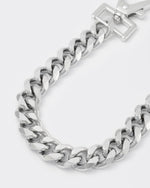 detail of cutting edge cuban chain bracelet with 18kt white gold coating and oversize carabiner clasp with engraved logo