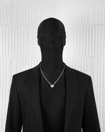 man with black suit wearing 18k white gold coated heart pendant necklace with red-yellow hand painted enamel and satined finishing