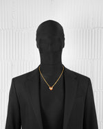 man with black suit wearing 18k yellow gold coated heart pendant necklace with red-yellow hand painted enamel and satined finishing