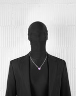 man with black suit wearing 18k white gold coated heart pendant necklace with hand-set micropavè stones in white and purple-blue hand painted enamel