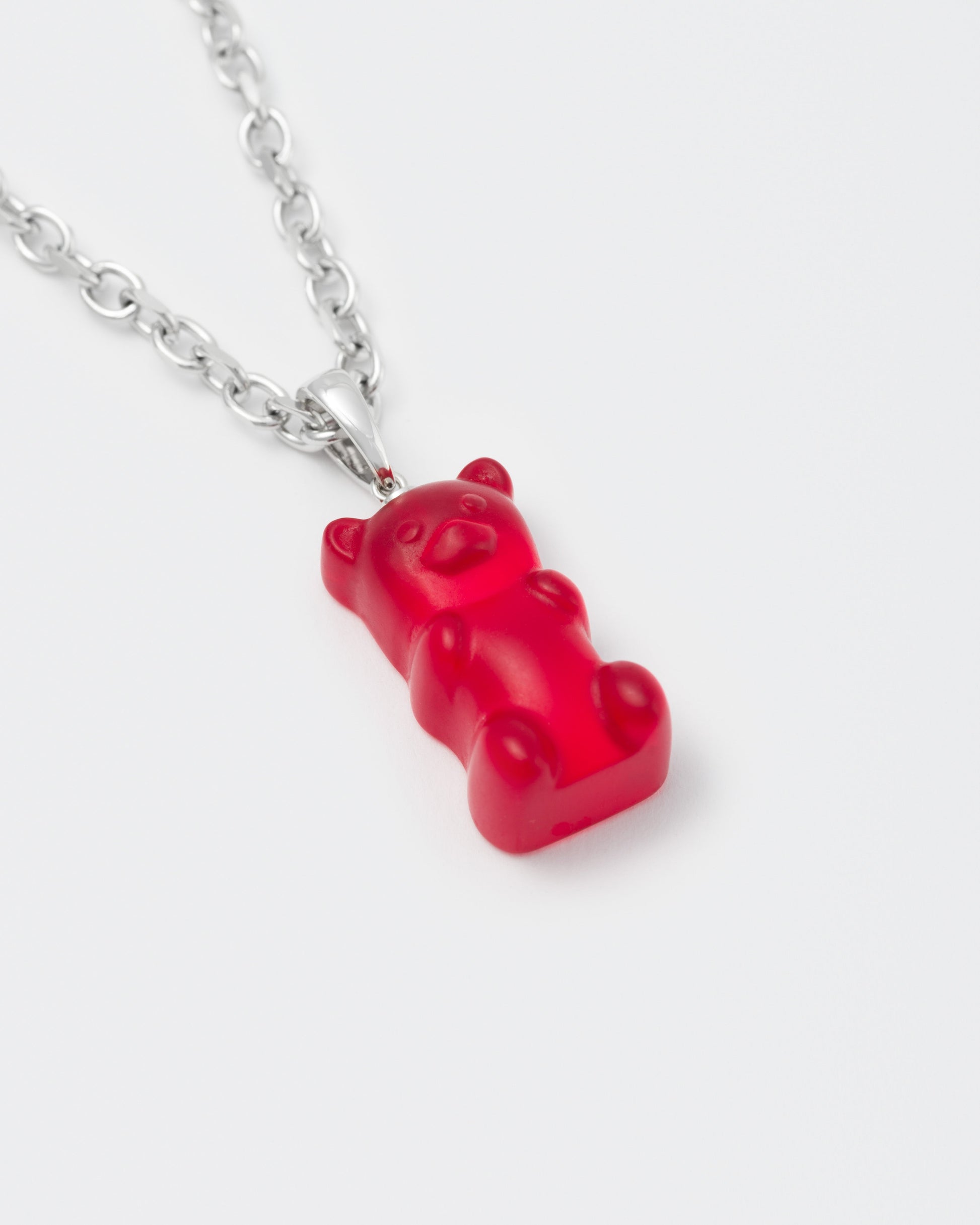 detail of 18k white gold coated gummy bear pendant necklace with 3D cut sandblasted crystal in red and 3mm rolo chain