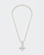 detail of 18k white gold coated reversed cross pendant necklace with hand-set stones in white and tennis chain