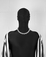 man with black suit wearing 18k white gold coated oversize rolo necklace with all around hand-set micropavé stones in white