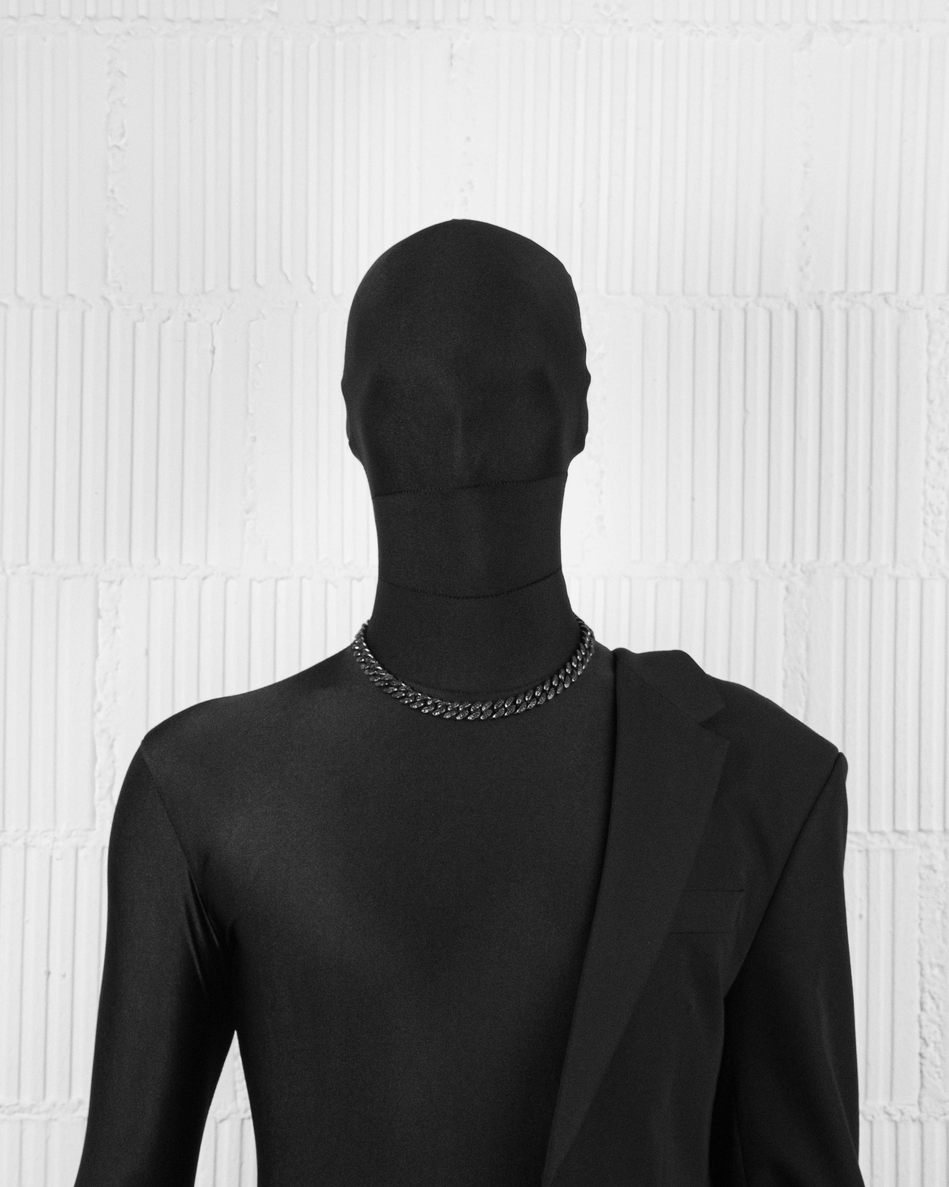 man with black suit wearing Black PVD coated cuban chain necklace with hand-set micropavé stones in black