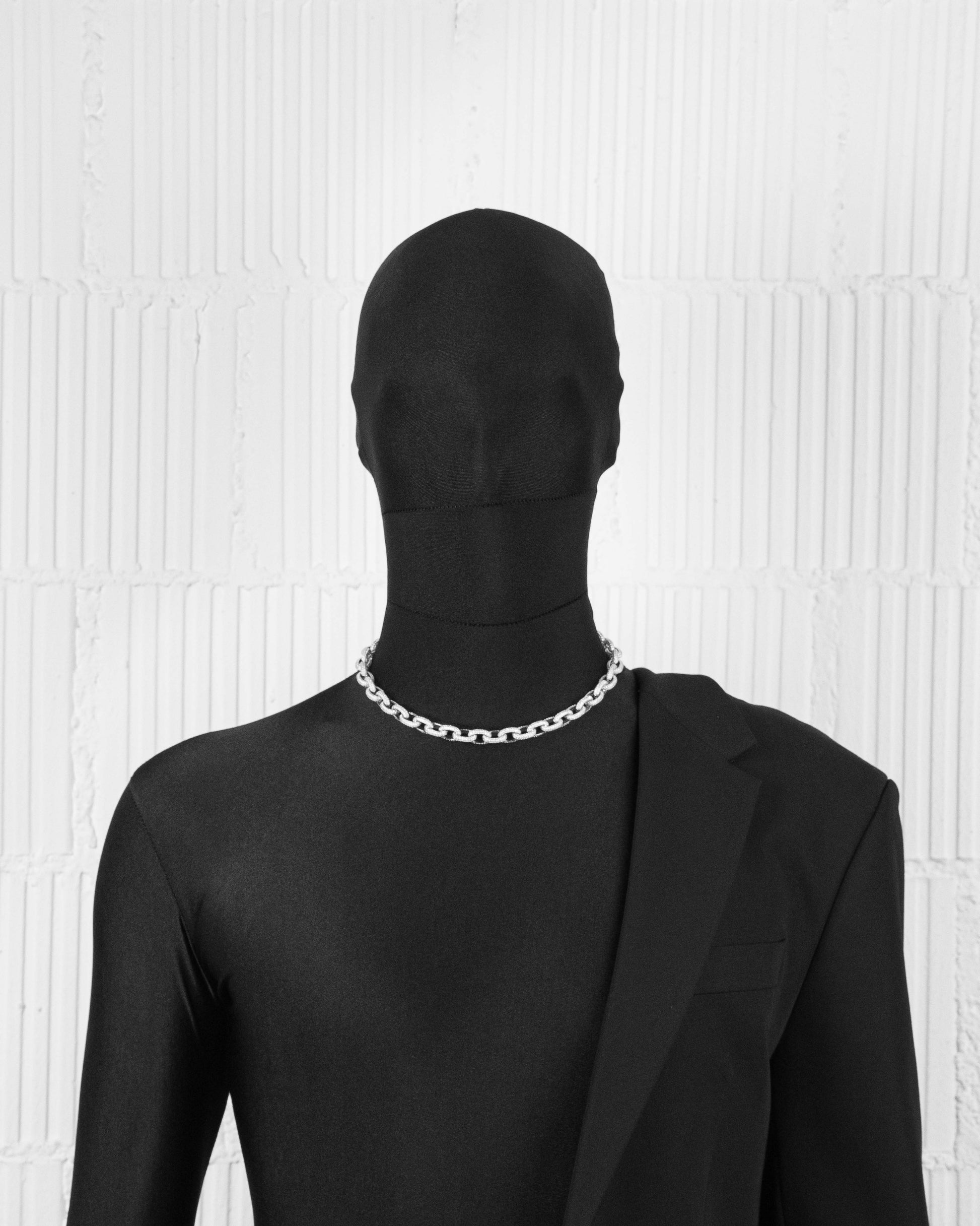man with black suit wearing 18k white gold coated rolo chain necklace with all-around hand-set micropavé stones in white