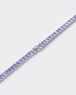detail of 18k white gold coated tennis chain necklace with hand-set princess-cut stones in amethyst purple