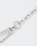 detail of 18k white gold coated rolo chain choker with lasered logo oversize carabiner clasp