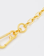 detail of 18k yellow gold coated rolo chain choker with lasered logo oversize carabiner clasp.