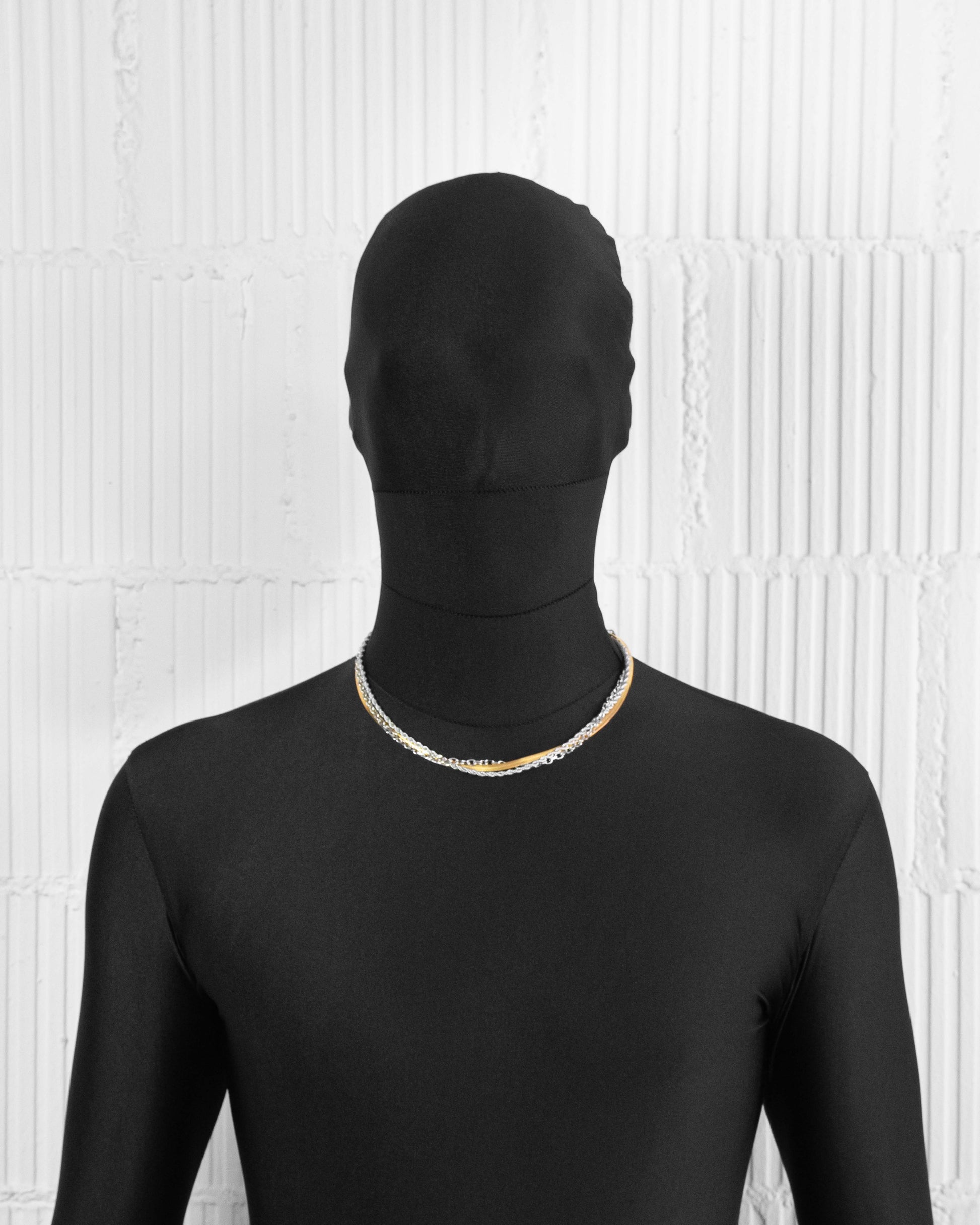 man with black suit wearing 18k yellow and white gold coated layers necklace with 3mm rope and cable chain and contrasting 4mm herringbone chain