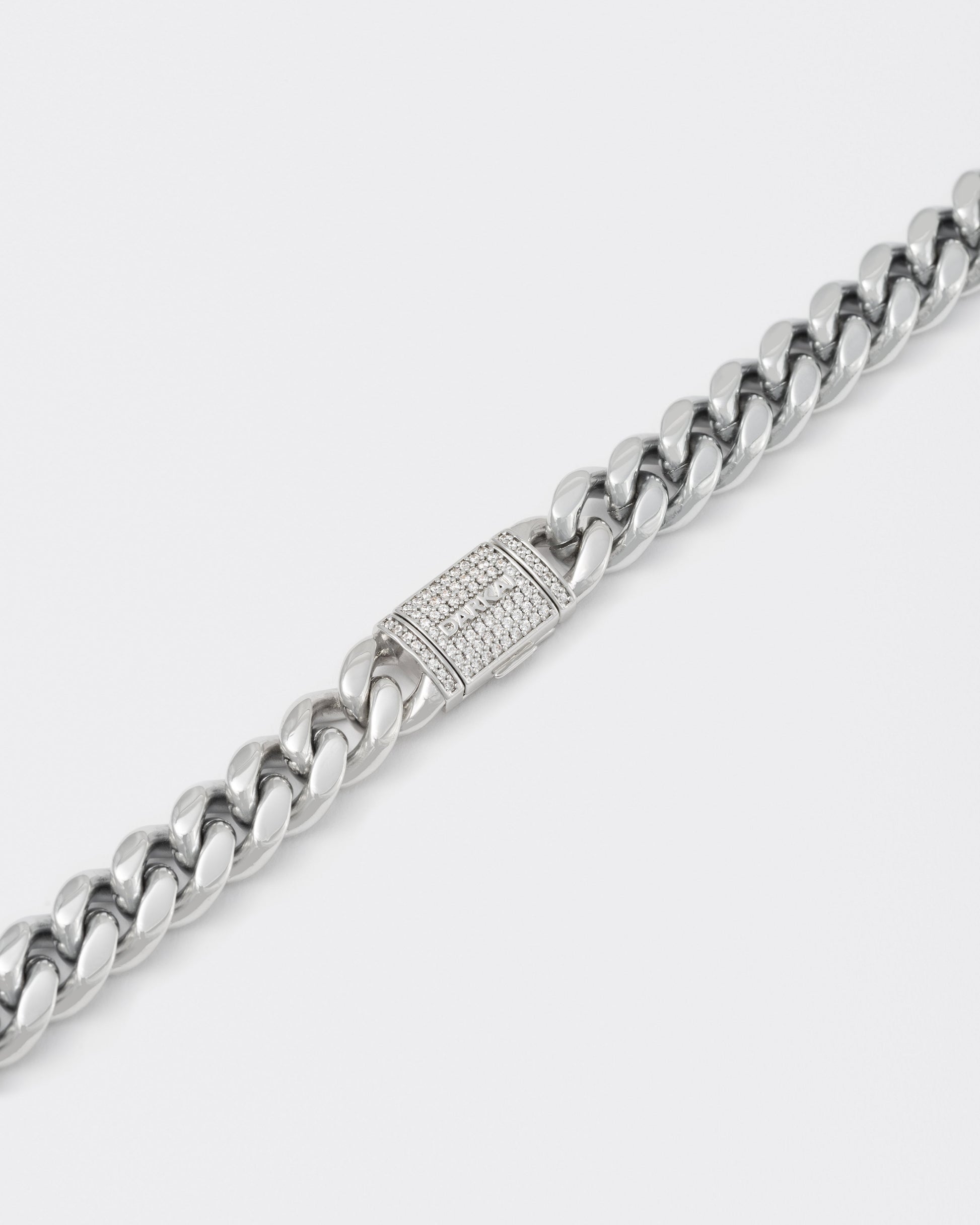 detail of 18k white gold coated cuban chain necklace with hand-set micropavé stones in white