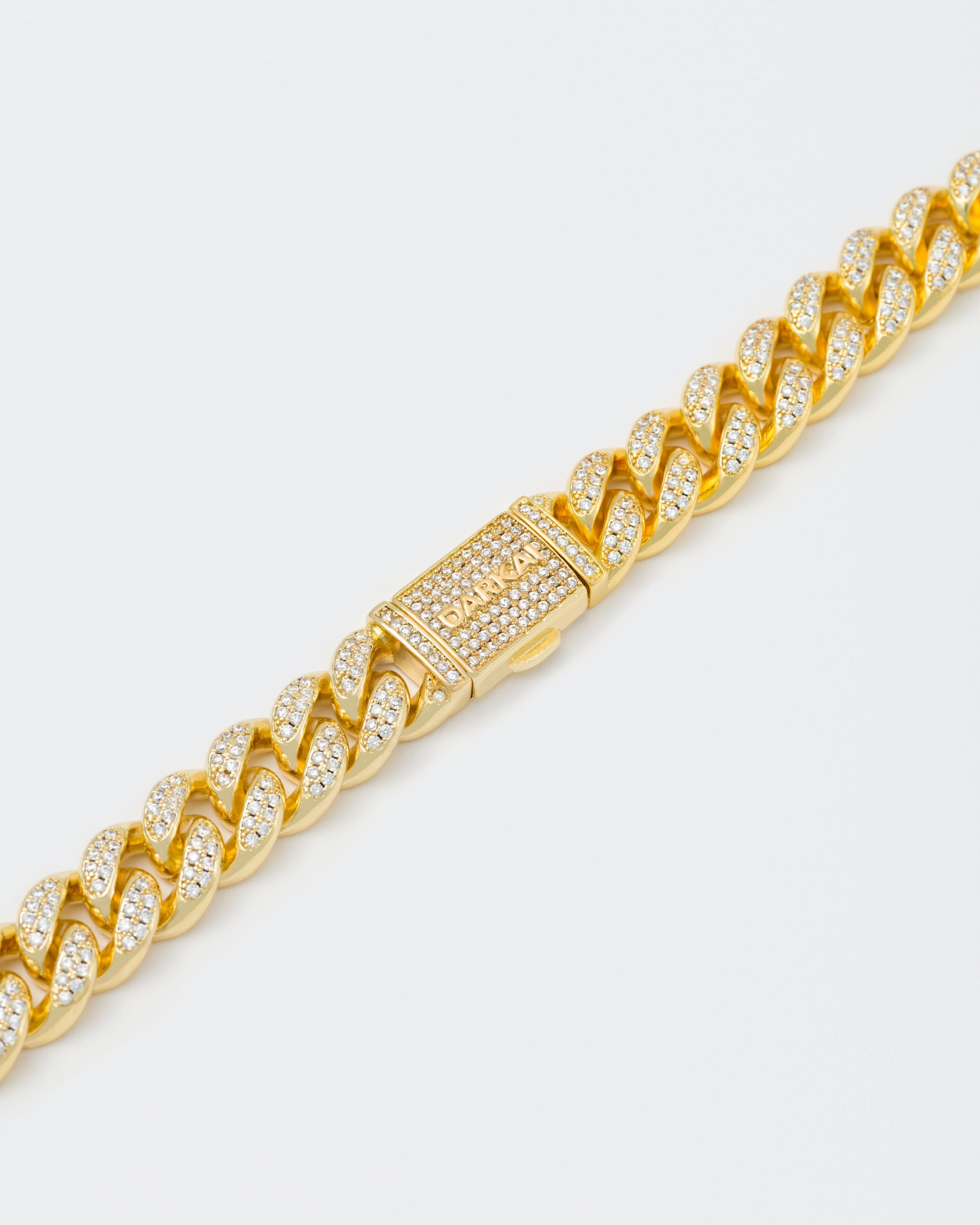detail of 18k yellow gold coated cuban chain necklace with hand-set micropavé stones in white