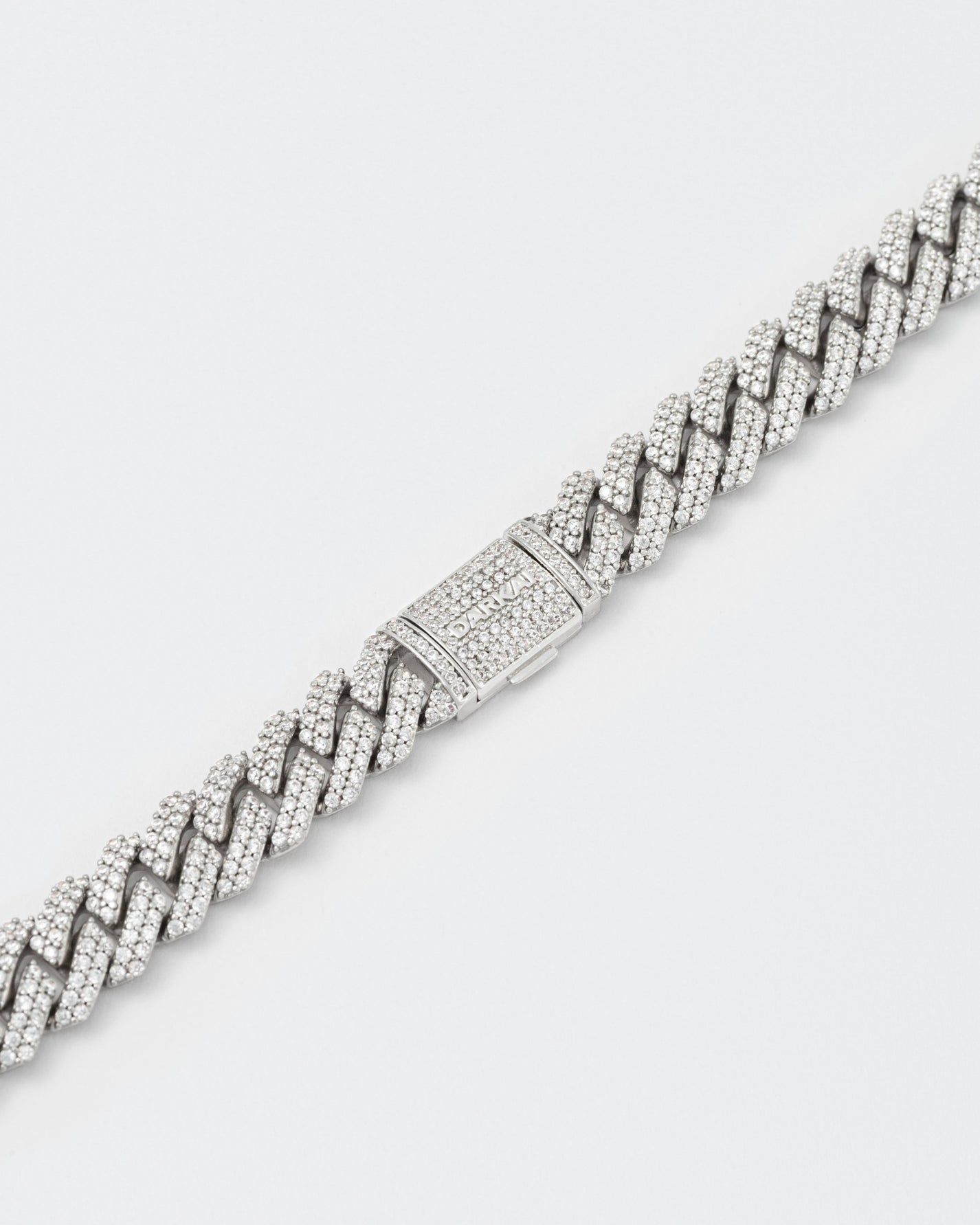 detail of clasp of 18k white gold coated mini prong chain necklace with hand-set micropavé stones in white