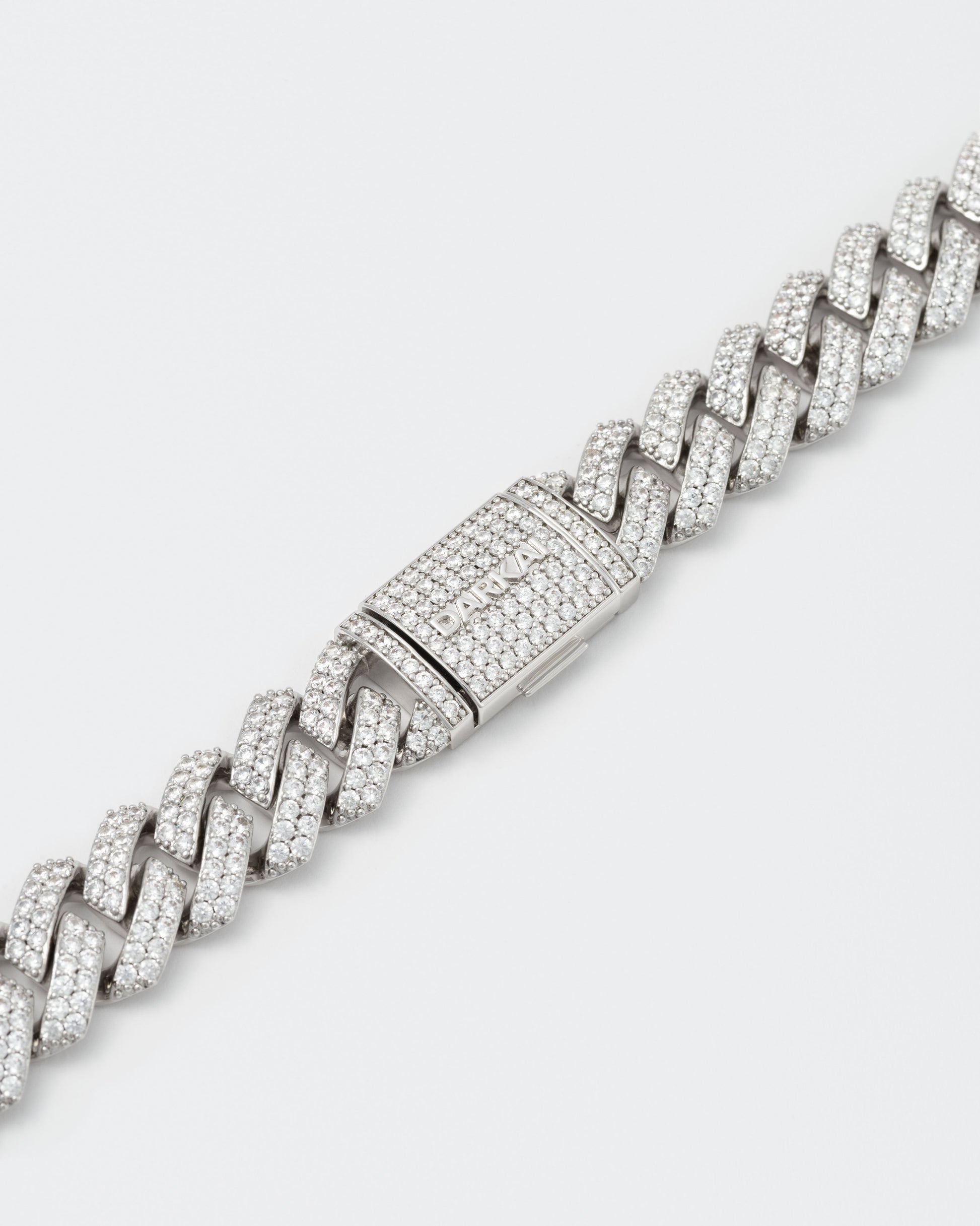 detail of clasp of 18k white gold coated prong chain necklace with hand-set micropavé stones in white