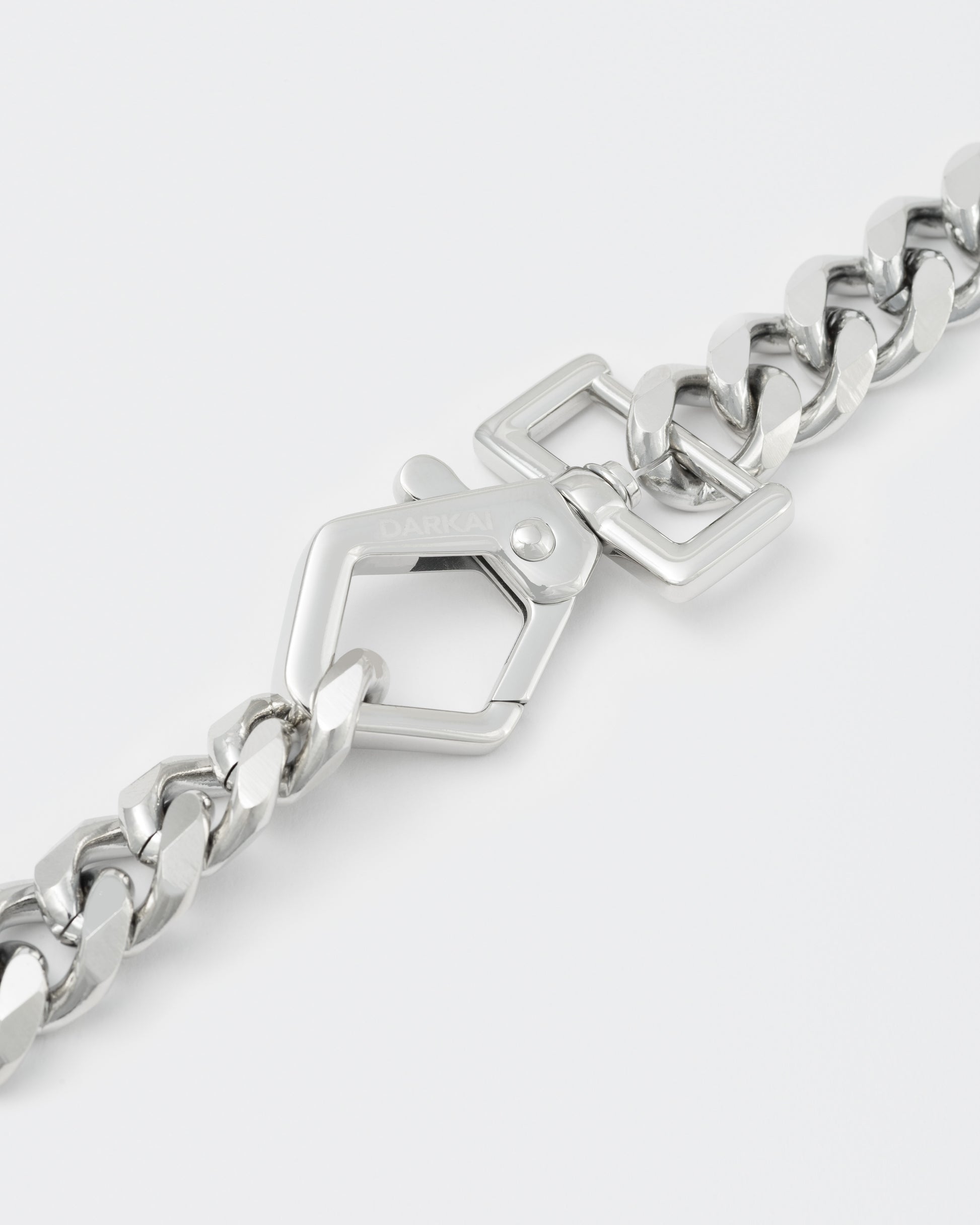 detail of cutting edge cuban chain choker with 18kt white gold coating and oversize carabiner clasp with engraved logo