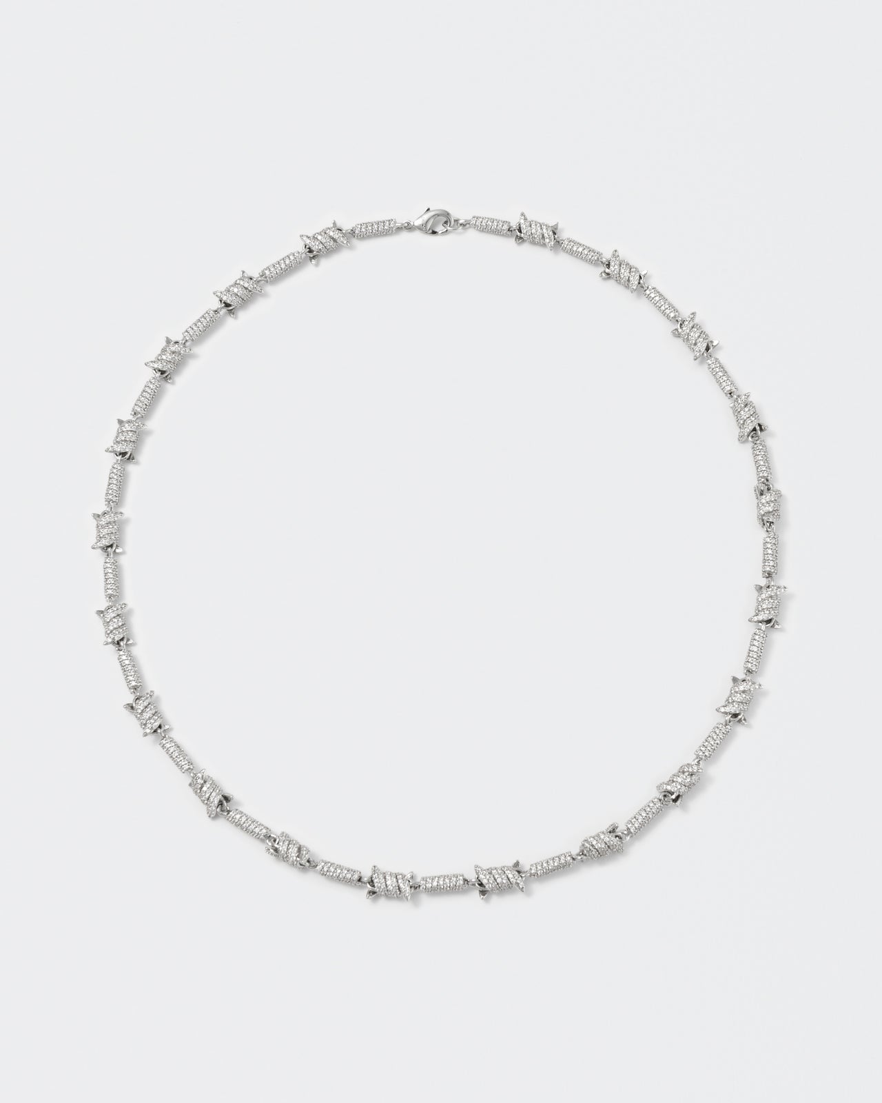 Barbed Wire necklace with 18kt white gold coating and hand-set micropavé stones in diamond white. Lobster clasp closure with logo