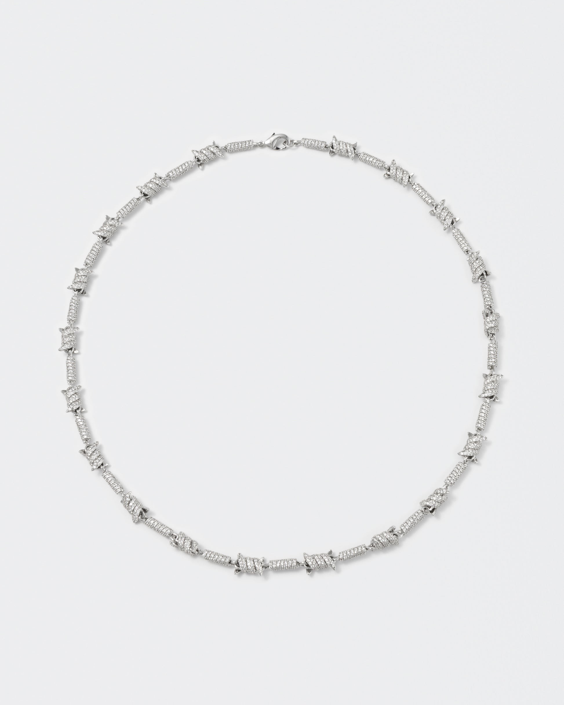 Barbed Wire necklace with 18kt white gold coating and hand-set micropavé stones in diamond white. Lobster clasp closure with logo