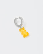detail of 18k white gold coated gummy bear mono earring with 3D cut sandblasted crystal in yellow
