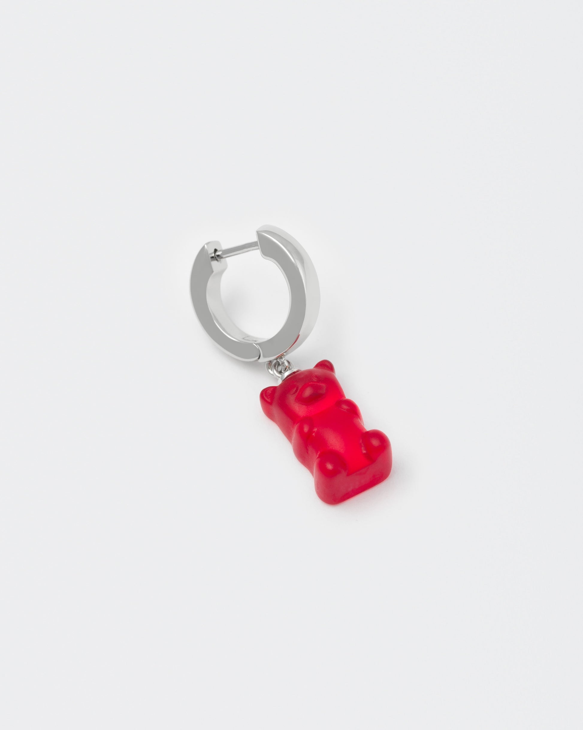 detail of 18k white gold coated gummy bear mono earring with 3D cut sandblasted crystal in red