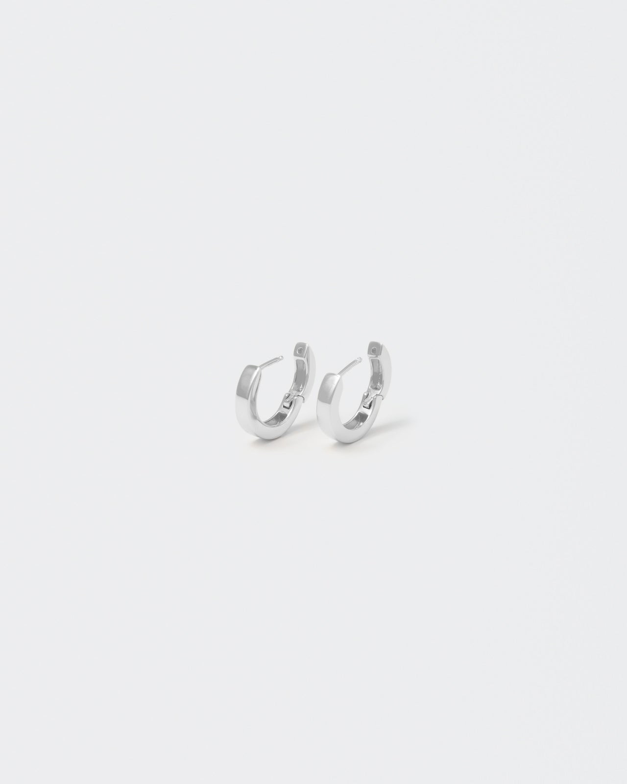 18k white gold coated hoop earrings with lasered logo and details on the inside