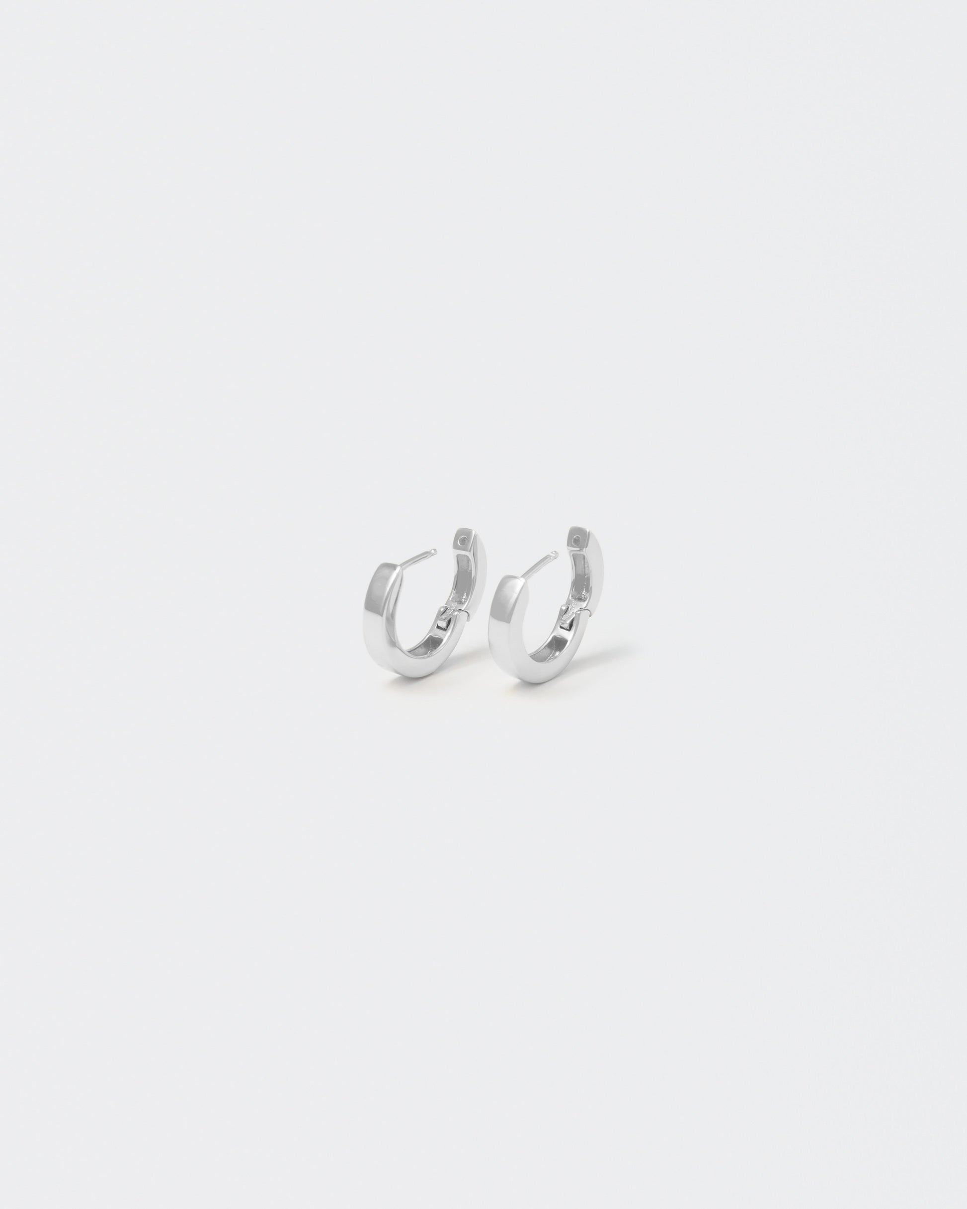 18k white gold coated hoop earrings with lasered logo and details on the inside